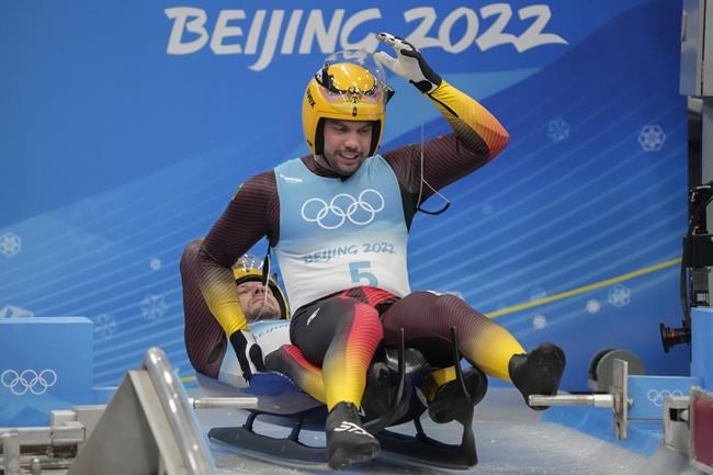 Tobias Wendl and Tobias Arlt, of Germany, prepare to start the luge doubles run 1 at the 2022 Winter Olympics, Wednesday, Feb. 9, 2022, in the Yanqing district of Beijing. (AP Photo/Mark Schiefelbein)