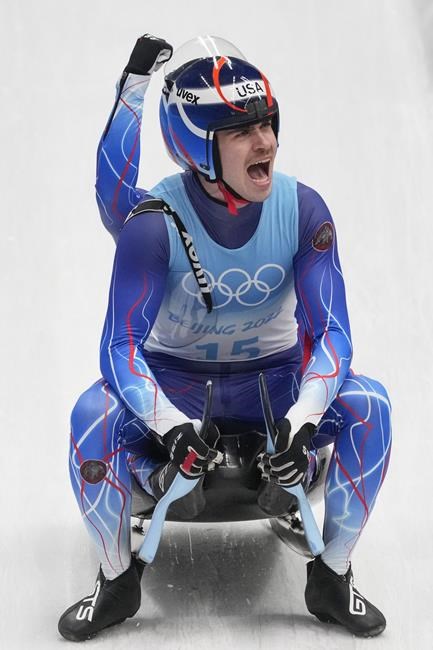 Zachary Di Gregorio and Sean Hollander, of the United States, celebrate after finishing the luge doubles run 2 at the 2022 Winter Olympics, Wednesday, Feb. 9, 2022, in the Yanqing district of Beijing. (AP Photo/Dmitri Lovetsky)