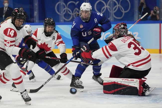 Canada goaltender Ann-Renee Desbiens (35) blocks a shot as United States' Hilary Knight (21) watches for a rebound during a preliminary round women's hockey game at the 2022 Winter Olympics, Tuesday, Feb. 8, 2022, in Beijing. THE CANADIAN PRESS/AP/Petr David Josek