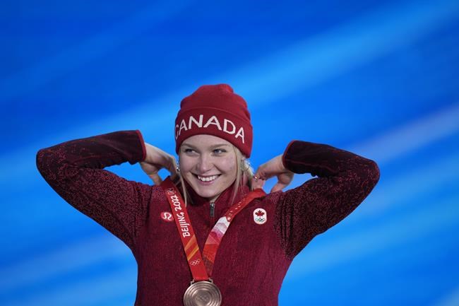 Meryeta O'Dine smiles as she accepts the bronze medal during a medal ceremony for the women's snowboard cross finals competition at the 2022 Winter Olympics, Wednesday, Feb. 9, 2022, in Zhangjiakou, China. THE CANADIAN PRESS/AP-Frank Augstein
