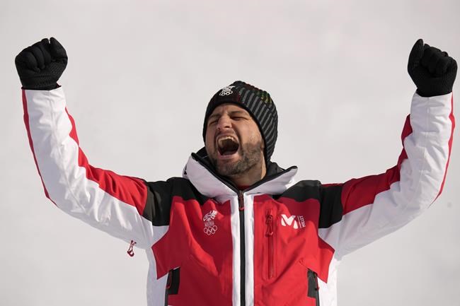 Johannes Strolz, of Austria, gold, celebrates during the medal ceremony for the the men's combined at the 2022 Winter Olympics, Thursday, Feb. 10, 2022, in the Yanqing district of Beijing. (AP Photo/Luca Bruno)