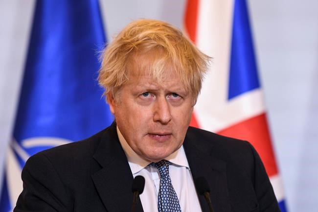 Britain's Prime Minister Boris Johnson speaks during a joint press conference with Poland's Prime Minister Mateusz Morawiecki in Warsaw, Poland, Thursday Feb. 10, 2022. (Daniel Leal/Pool via AP)