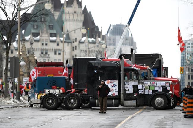 Trucks, now parked perpendicular to Wellington Street, are seen in front of the Chateau Laurier as a protest against COVID-19 restrictions that has been marked by gridlock and the sound of truck horns reaches its 14th day, in Ottawa, Thursday, Feb. 10, 2022. Parliamentarians will hear from the crowdfunding site GoFundMe about what measures it has in place to prevent the funding of extremism. THE CANADIAN PRESS/Justin Tang