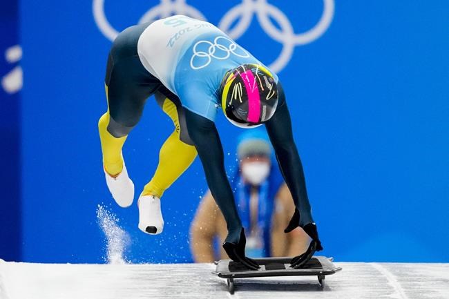 Vladyslav Heraskevych, of Ukraine, starts the men's skeleton run 3 at the 2022 Winter Olympics, Friday, Feb. 11, 2022, in the Yanqing district of Beijing. (AP Photo/Mark Schiefelbein)