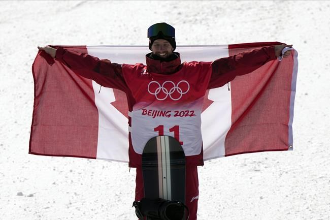 Gold medallist Canada's Max Parrot celebrates during the award ceremony for the men's slopestyle at the 2022 Winter Olympics, Monday, Feb. 7, 2022, in Zhangjiakou, China. (AP Photo/Francisco Seco)