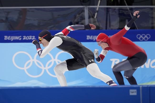 Jordan Stolz of the United States and Bjoern Magnussen of Norway, right, compete in the men's speedskating 500-meter race at the 2022 Winter Olympics, Saturday, Feb. 12, 2022, in Beijing. (AP Photo/Sue Ogrocki)