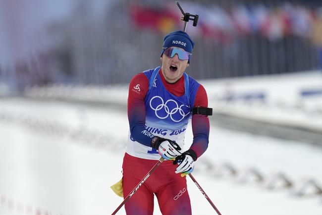 Johannes Thingnes Boe of Norway crosses the finish line during the men's 10-kilometer sprint competition at the 2022 Winter Olympics, Saturday, Feb. 12, 2022, in Zhangjiakou, China. (AP Photo/Kirsty Wigglesworth)
