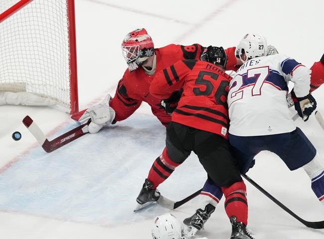 Team Canada goaltender Eddie Pasquale (80) lets in the second goal as Team Canada defender Maxim Noreau (56) and Team United States forward Noah Cates (27) look on during first period men’s ice hockey preliminary action at the Beijing Olympic Winter Games, in Beijing, Saturday, Feb. 12, 2022. Pasquale made 23 saves and blamed himself for Canada's 4-2 loss to the United States in men's hockey. THE CANADIAN PRESS/Ryan Remiorz
