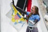 Katie Tannenbaum, of Virgin Islands, celebrates after the women's skeleton run 3 at the 2022 Winter Olympics, Saturday, Feb. 12, 2022, in the Yanqing district of Beijing. (AP Photo/Mark Schiefelbein)