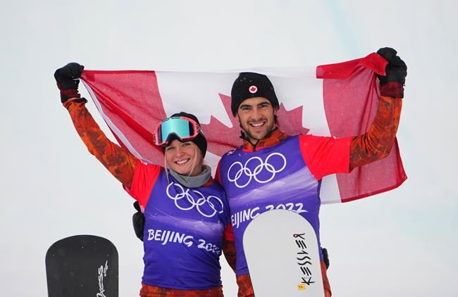 Canada's Meryeta O'Dine and Eliot Grondin celebrate their bronze medal in mixed team snowboard cross at the 2022 Beijing Winter Olympics in Zhangjiakou, China on Saturday, Feb. 12, 2022. THE CANADIAN PRESS/Sean Kilpatrick