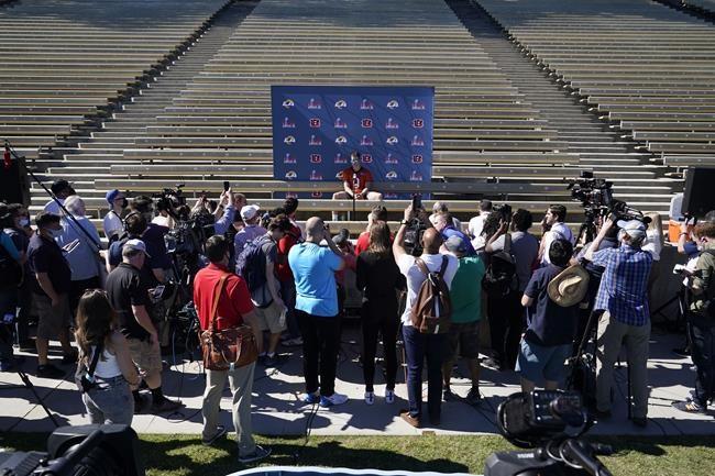 Members of the news media crowd around Cincinnati Bengals quarterback Joe Burrow during a press conference following the team's NFL football practice Friday, Feb. 11, 2022, in Los Angeles. The Cincinnati Bengals play the Los Angeles Rams in the Super Bowl Sunday Feb. 13. (AP Photo/Marcio Jose Sanchez)