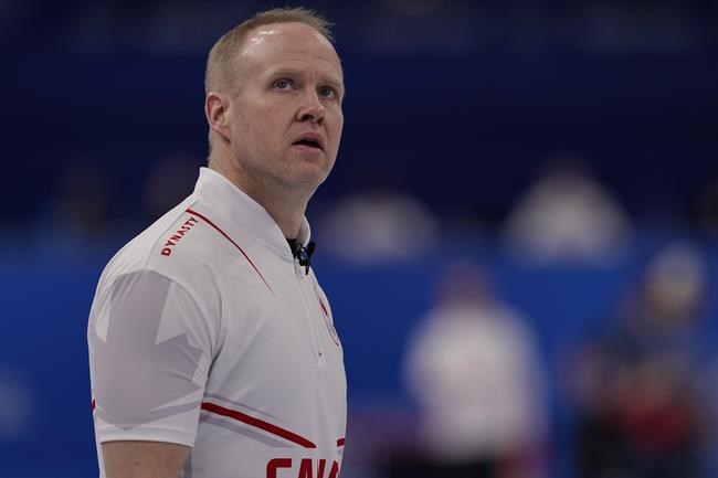 Canada's Mark Nichols looks at a screen during a men's curling match against the United States at the Beijing Winter Olympics Sunday, Feb. 13, 2022, in Beijing. (AP Photo/Brynn Anderson)