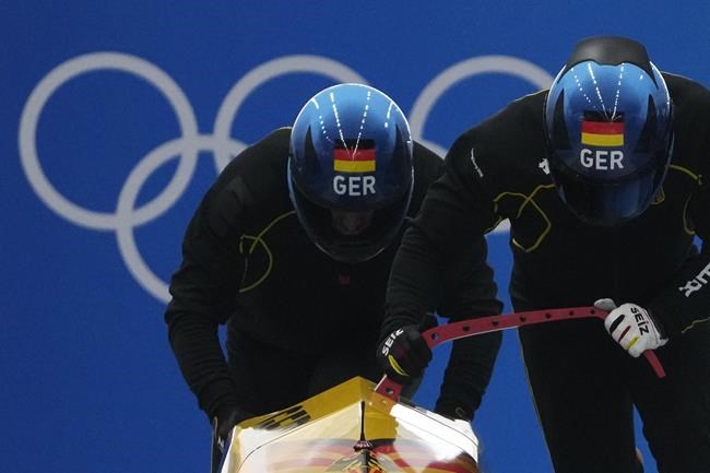 Francesco Friedrich of Germany starts during a 2-man bobsleigh training heat at the 2022 Winter Olympics, Saturday, Feb. 12, 2022, in the Yanqing district of Beijing. (AP Photo/Pavel Golovkin)