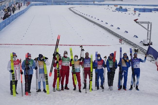 From left, silver medal finishers Norway, Gold medal finishers Russian Olympic Committee and bronze medal finishers France pose for photographers after the men's 4 x 10km relay cross-country skiing competition at the 2022 Winter Olympics, Sunday, Feb. 13, 2022, in Zhangjiakou, China. (AP Photo/Aaron Favila)