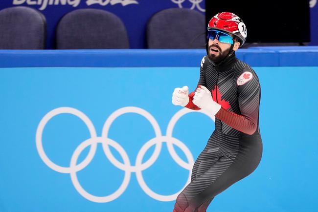 Canada's Steven Dubois celebrates his bronze medal finish at the finish line for the men's 500 metre short-track speed skating final at the Olympic Winter Games in Beijing, Sunday, Feb. 13, 2022. THE CANADIAN PRESS/Paul Chiasson