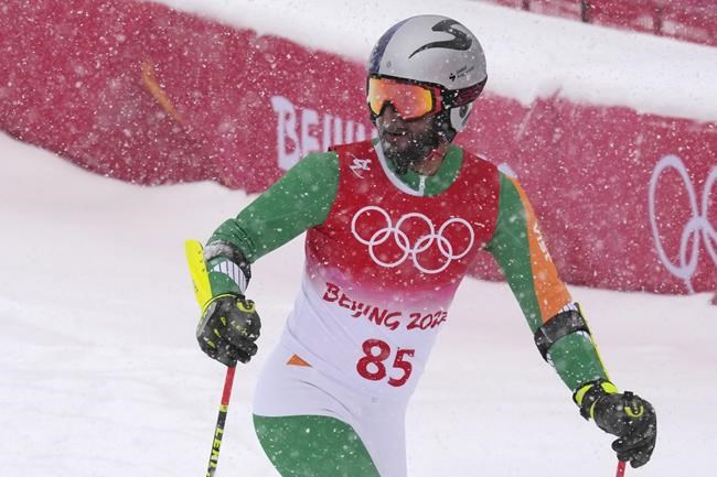 Arif Mohd Khan, of India looks up after finishing the first run of the men's giant slalom at the 2022 Winter Olympics, Sunday, Feb. 13, 2022, in the Yanqing district of Beijing. (AP Photo/Luca Bruno)