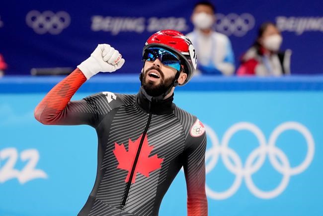 Canada's Steven Dubois celebrates his bronze medal finish at the finish line for the men's 500 metre short-track speed skating final at the Olympic Winter Games in Beijing, Sunday, Feb. 13, 2022. THE CANADIAN PRESS/Paul Chiasson