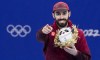 Canada's Steven Dubois celebrates his bronze medal in the men's 500 metre short-track speed skating on the podium at the Olympic Winter Games in Beijing, Sunday, Feb. 13, 2022. THE CANADIAN PRESS/Paul Chiasson