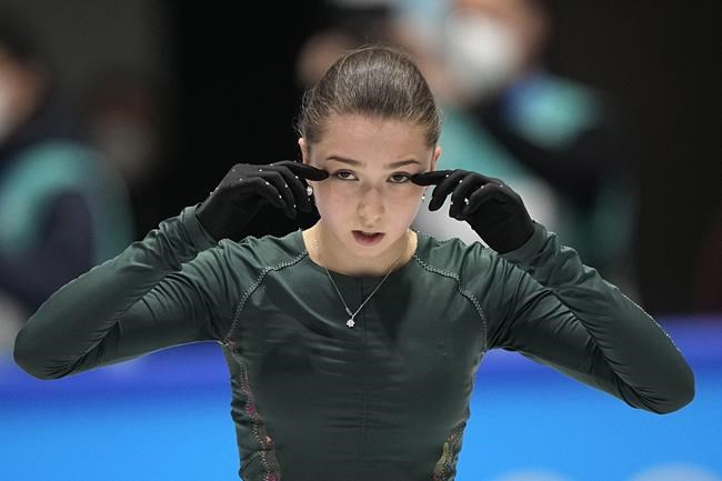 Kamila Valieva, of the Russian Olympic Committee, wipes her eyes during a training session at the 2022 Winter Olympics, Sunday, Feb. 13, 2022, in Beijing. (AP Photo/David J. Phillip)