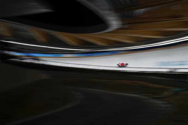 Natalie Maag, of Switzerland, slides during the luge women's singles run 1 at the 2022 Winter Olympics, Monday, Feb. 7, 2022, in the Yanqing district of Beijing. (AP Photo/Pavel Golovkin)