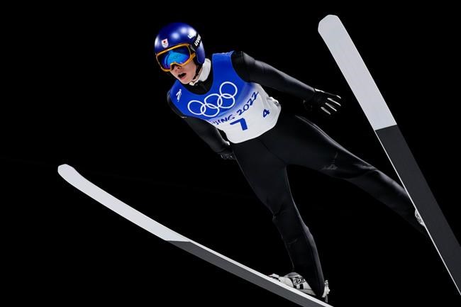 Ryoyu Kobayashi, of Japan, soars through the air during a men's team ski jumping trial round for competition at the 2022 Winter Olympics, Monday, Feb. 14, 2022, in Zhangjiakou, China. (AP Photo/Andrew Medichini)