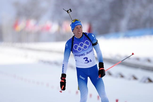 Quentin Fillon Maillet of France crosses the finish line in second during the men's 4x7.5-kilometer relay at the 2022 Winter Olympics, Tuesday, Feb. 15, 2022, in Zhangjiakou, China. (AP Photo/Kirsty Wigglesworth)
