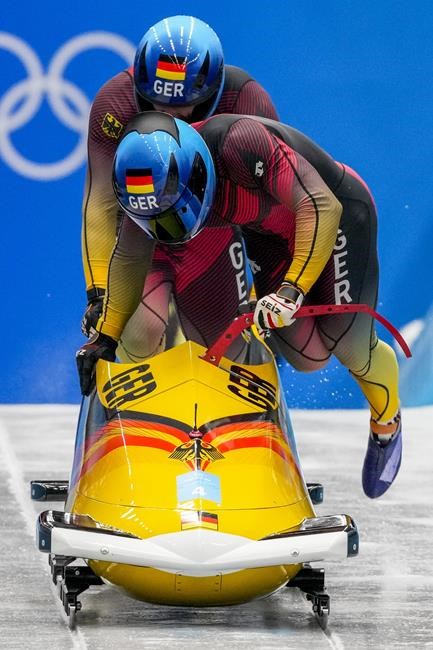 Francesco Friedrich and Thorsten Margis, of Germany, start the 2-man heat 3 at the 2022 Winter Olympics, Tuesday, Feb. 15, 2022, in the Yanqing district of Beijing. (AP Photo/Dmitri Lovetsky)
