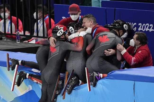Team Canada celebrate after winning the men's 5000-meters relay final during the short track speedskating competition at the 2022 Winter Olympics, Wednesday, Feb. 16, 2022, in Beijing. (AP Photo/David J. Phillip)