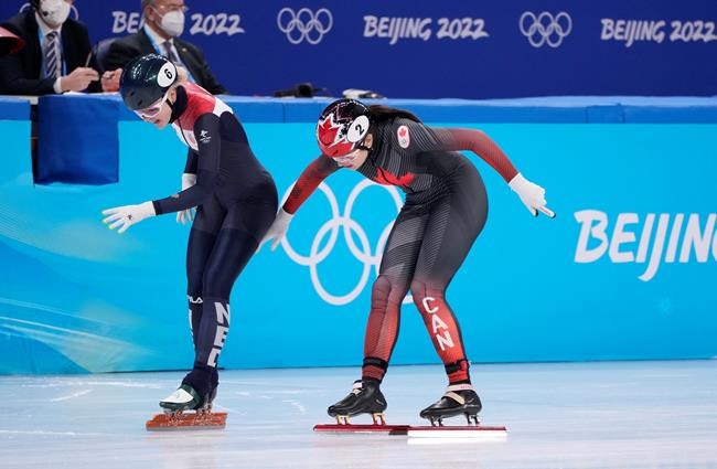 Xandra Velzeboer of the Netherlands (left) edges out Courtney Sarault of Canada at the finish line of the women's 1,500-metre short-track speedskating semifinal at the Beijing Winter Olympics in Beijing, China, on Wednesday, Feb. 16, 2022. THE CANADIAN PRESS/Paul Chiasson