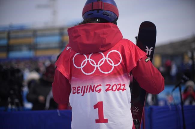 China's Eileen Gu talks to reporters after the women's halfpipe qualification at the 2022 Winter Olympics, Thursday, Feb. 17, 2022, in Zhangjiakou, China. (AP Photo/Francisco Seco)