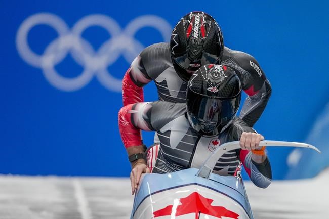 Justin Kripps and Cam Stones, of Canada, start the 2-man heat 1 at the 2022 Winter Olympics, Monday, Feb. 14, 2022, in the Yanqing district of Beijing. THE CANADIAN PRESS/AP-Pavel Golovkin