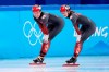 Kim Boutin (right) and Courtney Sarault of Canada smile after skating in the women's 1,500-metre short-track speedskating 