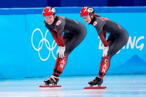 Kim Boutin (right) and Courtney Sarault of Canada smile after skating in the women's 1,500-metre short-track speedskating 