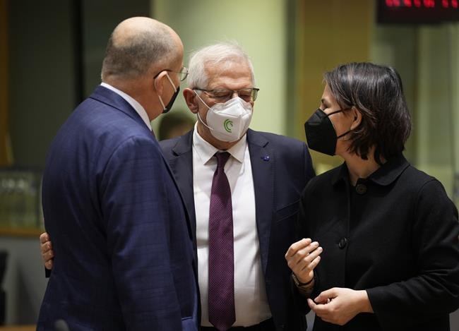 German Foreign Minister Annalena Baerbock, right, speaks with Poland's Foreign Minister Zbiegniew Rau, left, and European Union foreign policy chief Josep Borrell during a meeting of EU foreign ministers in Brussels, Monday, Feb. 21, 2022. The European Union's top diplomat, foreign policy chief Josep Borrell, welcomed the prospect of a summit but said that should diplomacy fail the 27-nation has finalized its package of sanctions for use if Putin orders an invasion. (AP Photo/Virginia Mayo)