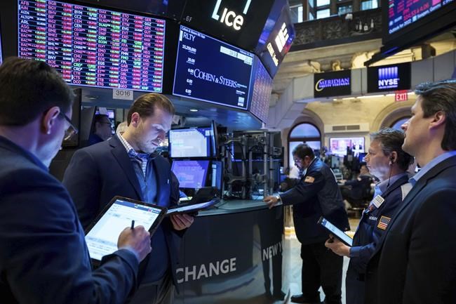 In this photo provided by the New York Stock Exchange, traders gather at a post on the floor, Thursday, Feb. 24, 2022. Stocks fell worldwide on Thursday after Russia's attack of Ukraine sent fear coursing through markets and upped the pressure on the high inflation already squeezing the global economy. (Courtney Crow/New York Stock Exchange via AP)
