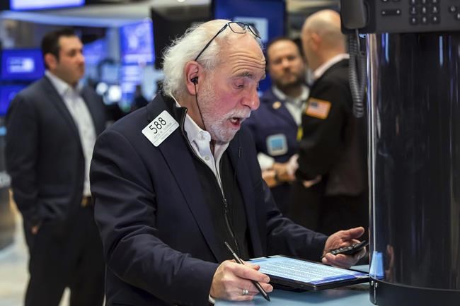 In this photo provided by the New York Stock Exchange, trader Peter Tuchman works on the trading floor, Thursday, Feb. 24, 2022. Markets shuddered worldwide Thursday and swung sharply after Russia's invasion of Ukraine threatened to push the high inflation squeezing the global economy even higher. (Courtney Crow/New York Stock Exchange via AP)