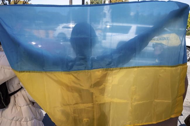 Protestors calling for a stop to the Russian invasion of Ukraine appeal to motorists outside of the federal building in Los Angeles Thursday, Feb. 24, 2022. (David Crane/The Orange County Register via AP)