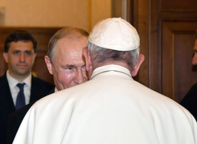 FILE - Pope Francis welcomes Russian President Vladimir Putin, left, on the occasion of their private audience at the Vatican, on July 4 2019. Pope Francis went to the Russian Embassy on Friday, Feb. 25, 2022 to personally “express his concern about the war,” the Vatican said, in an extraordinary, hands-on papal gesture that has no recent precedent. Usually, popes receive ambassadors and heads of state in the Vatican, and diplomatic protocol would have called for the Vatican foreign minister to summon the ambassador. (Alessandro Di Meo/Pool Photo via AP, File)