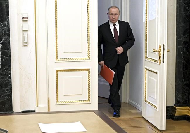 Russian President Vladimir Putin enters a hall to chair a Security Council meeting in Moscow, Russia, Friday, Feb. 25, 2022. (Alexei Nikolsky, Sputnik, Kremlin Pool Photo via AP)