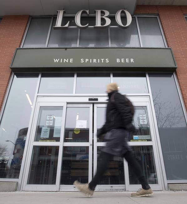 A person walks past an LCBO in Ottawa, Thursday March 19, 2020. The leader of Ontario's Liberal Party is asking the LCBO to stop selling Russian products following that country’s invasion of Ukraine. THE CANADIAN PRESS/Adrian Wyld
