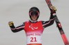 Alexis Guimond of Canada celebrates during the flower ceremony for the men's super-G, standing, at the 2022 Winter Paralympics, Sunday, March 6, 2022, in the Yanqing district of Beijing. THE CANADIAN PRESS/AP/Andy Wong