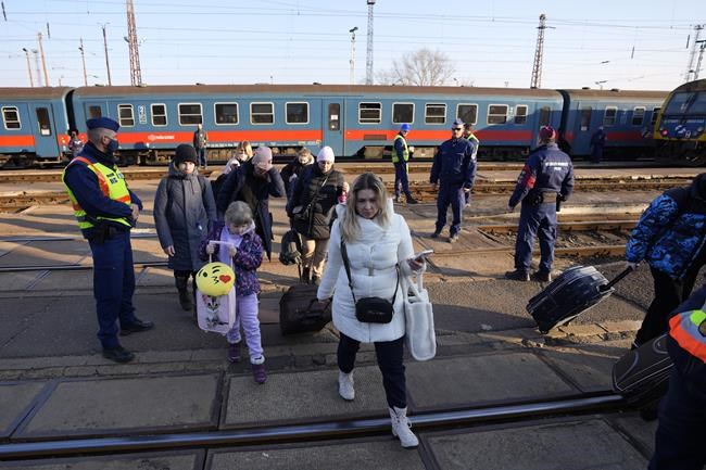 Refugees that fled Ukraine from the war arrive at the train station in Zahony, Hungary, Sunday, March 6, 2022. The number of Ukrainians forced from their country increased to 1.5 million and the Kremlin's rhetoric grew, with Russian President Vladimir Putin warning that Ukrainian statehood is in jeopardy. He likened the West's sanctions on Russia to
