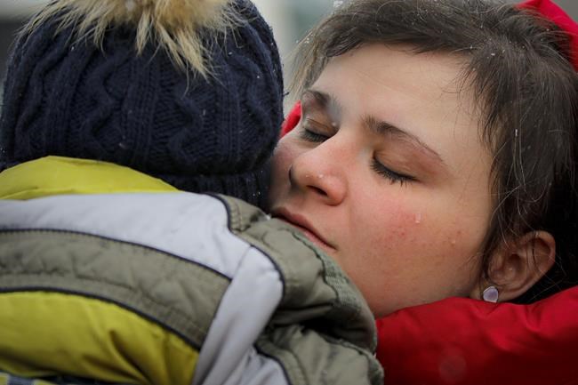 A refugee fleeing the conflict from neighbouring Ukraine cries as she holds her one-year-old son, Andrey, at the Romanian-Ukrainian border, in Siret, Romania, Monday, March 7, 2022. Russia announced yet another cease-fire and a handful of humanitarian corridors to allow civilians to flee Ukraine. Previous such measures have fallen apart and Moscow’s armed forces continued to pummel some Ukrainian cities with rockets Monday. (AP Photo/Andreea Alexandru)