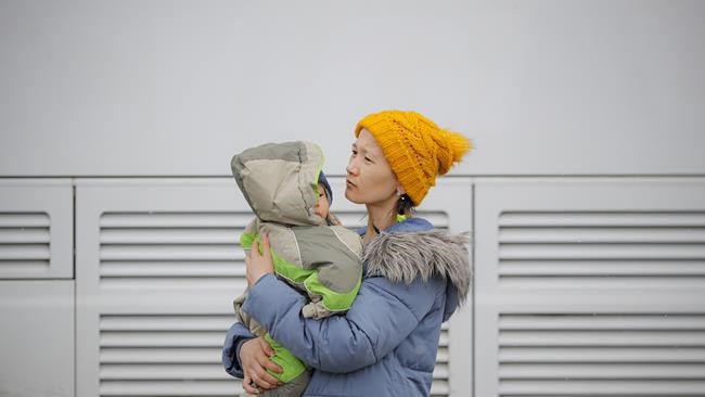 A refugee fleeing the conflict from neighbouring Ukraine holds a child, at the Romanian-Ukrainian border, in Siret, Romania, Monday, March 7, 2022. Russia announced yet another cease-fire and a handful of humanitarian corridors to allow civilians to flee Ukraine. Previous such measures have fallen apart and Moscow’s armed forces continued to pummel some Ukrainian cities with rockets Monday. (AP Photo/Andreea Alexandru)