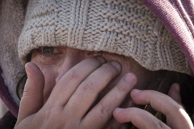 Masha Fesenko, from Kyiv, arrives at the border crossing in Medyka, Poland, Poland, Tuesday, March 8, 2022. Russia's invasion of Ukraine has set off the largest mass migration in Europe in decades, with more than 1.5 million people having crossed from Ukraine into neighboring countries. (AP Photo/Visar Kryeziu)