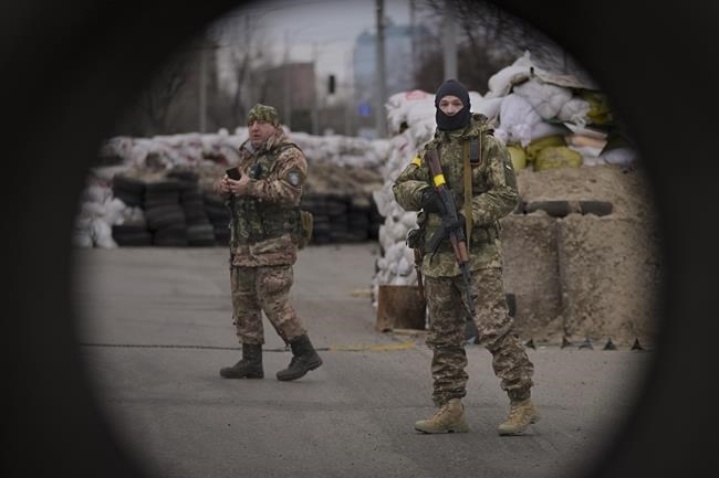 Ukrainian servicemen guard a checkpoint on a main road in Kyiv, Ukraine, Monday, March 7, 2022. (AP Photo/Vadim Ghirda)