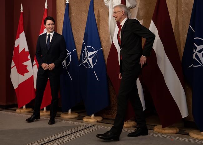 Canadian Prime Minister Justin Trudeau smiles at Latvian Prime Minister Krisjanis Karins as they leave a photo op before a meeting at the prime ministers office in Riga, Latvia, Tuesday, March 8, 2022. THE CANADIAN PRESS/Adrian Wyld