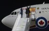 Canadian Prime Minister Justin Trudeau waves as he disembarks a government plane in Berlin, Germany, Tuesday, March 8, 2022. THE CANADIAN PRESS/Adrian Wyld