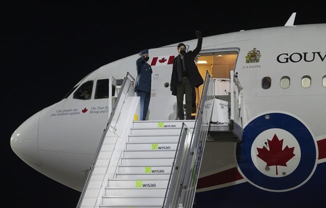 Canadian Prime Minister Justin Trudeau waves as he disembarks a government plane in Berlin, Germany, Tuesday, March 8, 2022. THE CANADIAN PRESS/Adrian Wyld