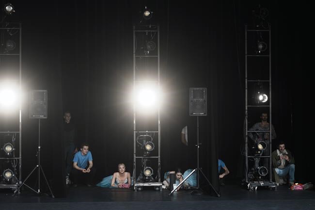Ukrainian dancers of the Kyiv City Ballet company watch a performance at the Theatre de Chatelet, in Paris, Tuesday, March 8, 2022. The Kyiv City Ballet danced to a full house in Paris for the last show of a French tour that has left the company stranded after the war broke out in Ukraine. They described being physically and emotionally exhausted. Being given the opportunity to train and dance was for many a chance to focus on something other than the war. (AP Photo/Thibault Camus)